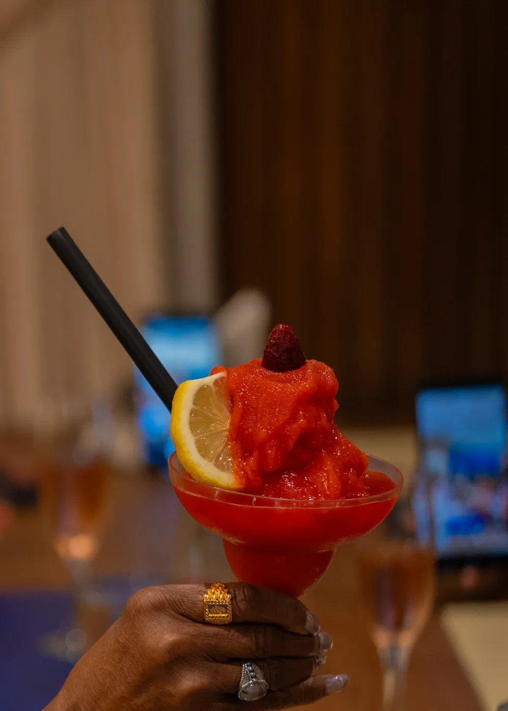 Red frozen cocktail garnished with citrus at Le Pavillon